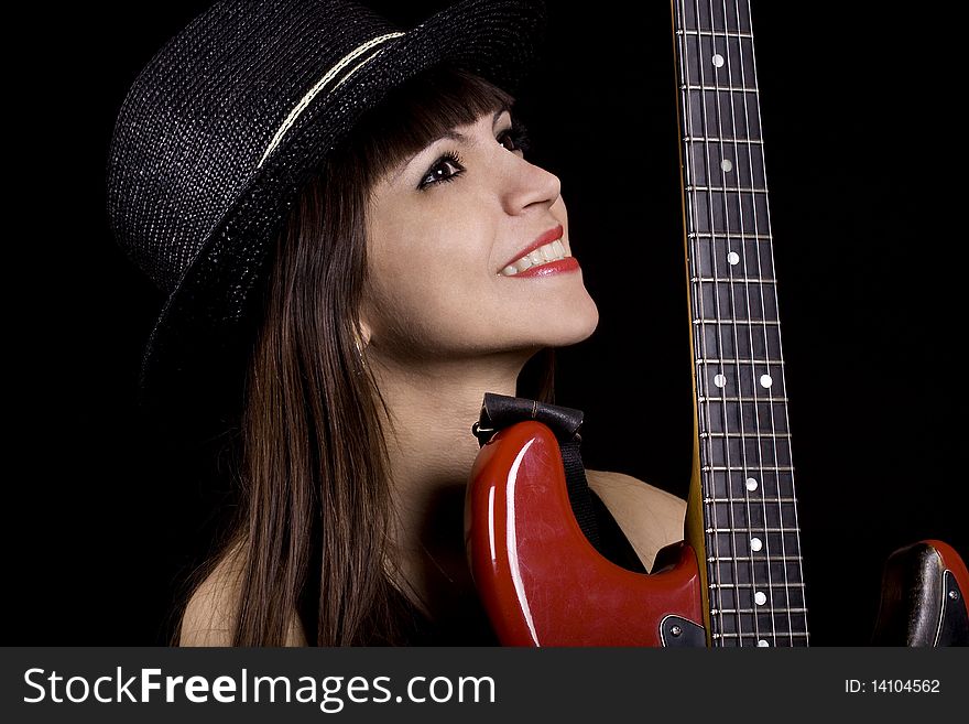 Female country singer holding a red guitar