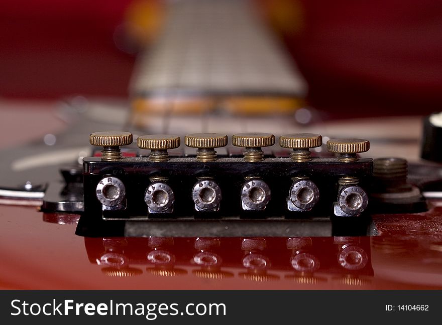 Close-up on an electric guitar on red satin background. Close-up on an electric guitar on red satin background