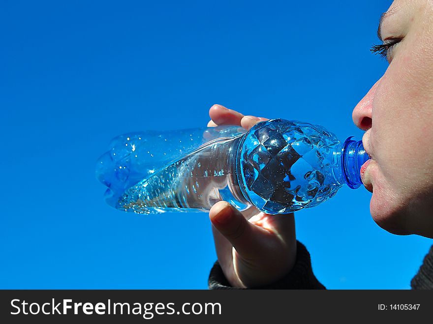 Water. Girl drinks from the bottle.