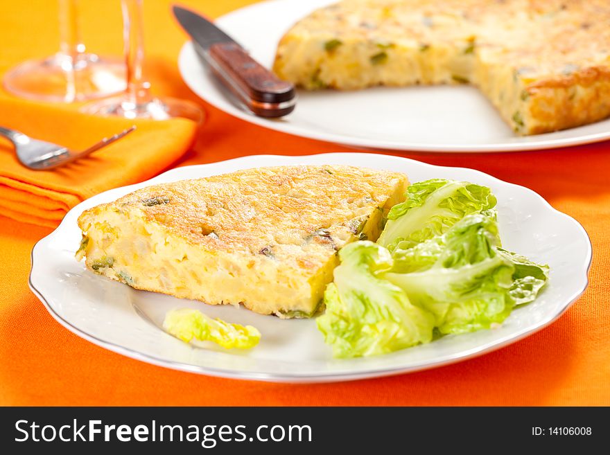 Potato omelette with olive oil and green pepper isolated