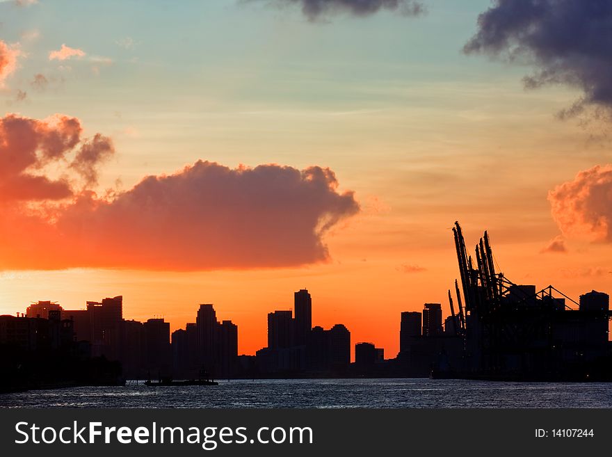 Beautiful colorful sunset over the port of Miami Florida with downtown buildings seen in the distance