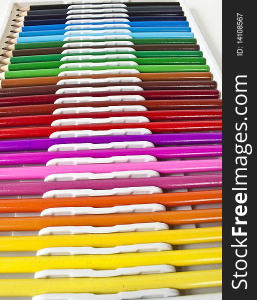 A line of colored pencils in various colors. A line of colored pencils in various colors