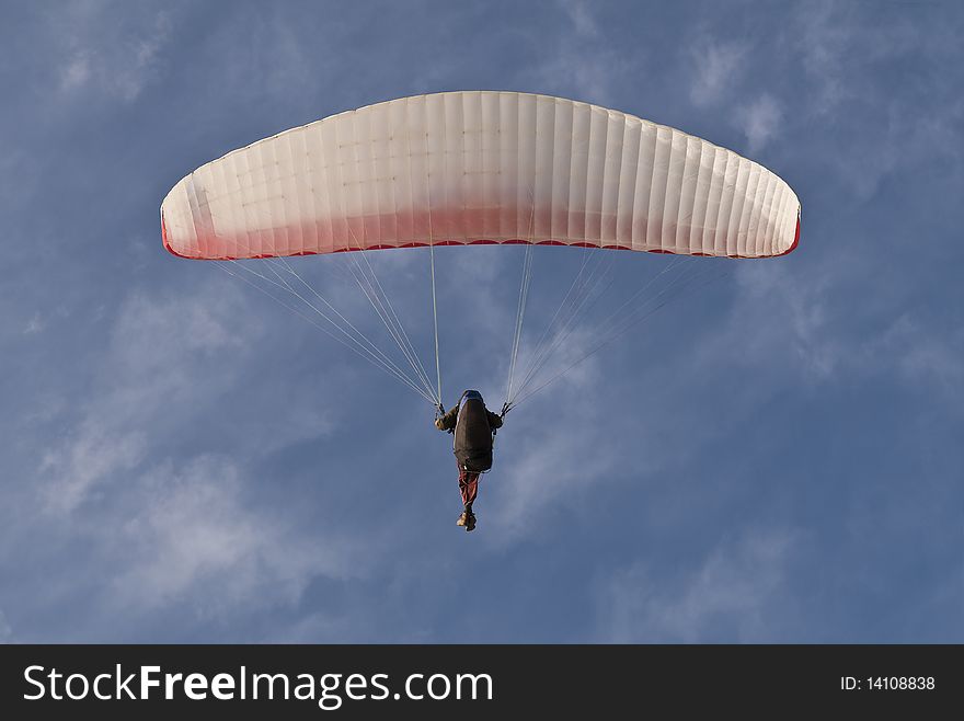 Single  Paraglider on blue sky with clouds background