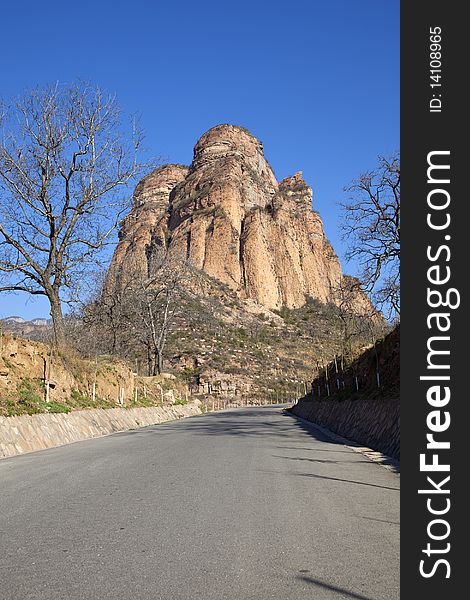 The asphalt road towards the rocky mountain in China. The asphalt road towards the rocky mountain in China