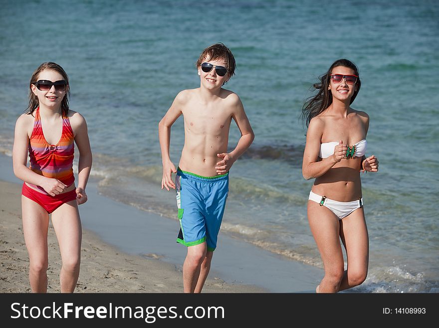 Young teenagers jogging along the shoreline enjoying Miami Beach.