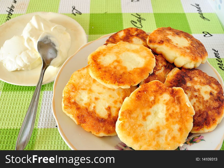 Image fried cheese fritters in a deep saucer with sour