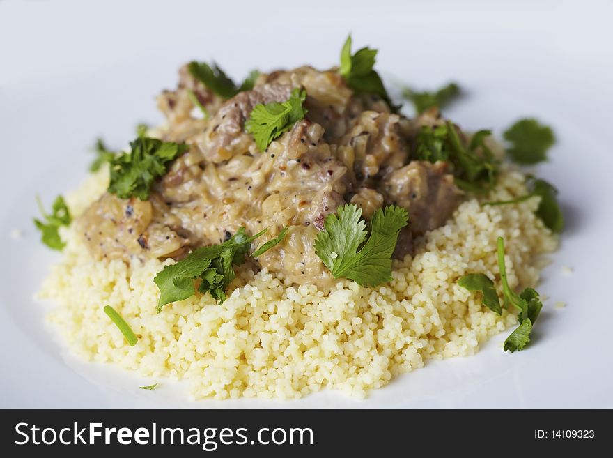 Couscous with coconut milk lamb curry and coriander.