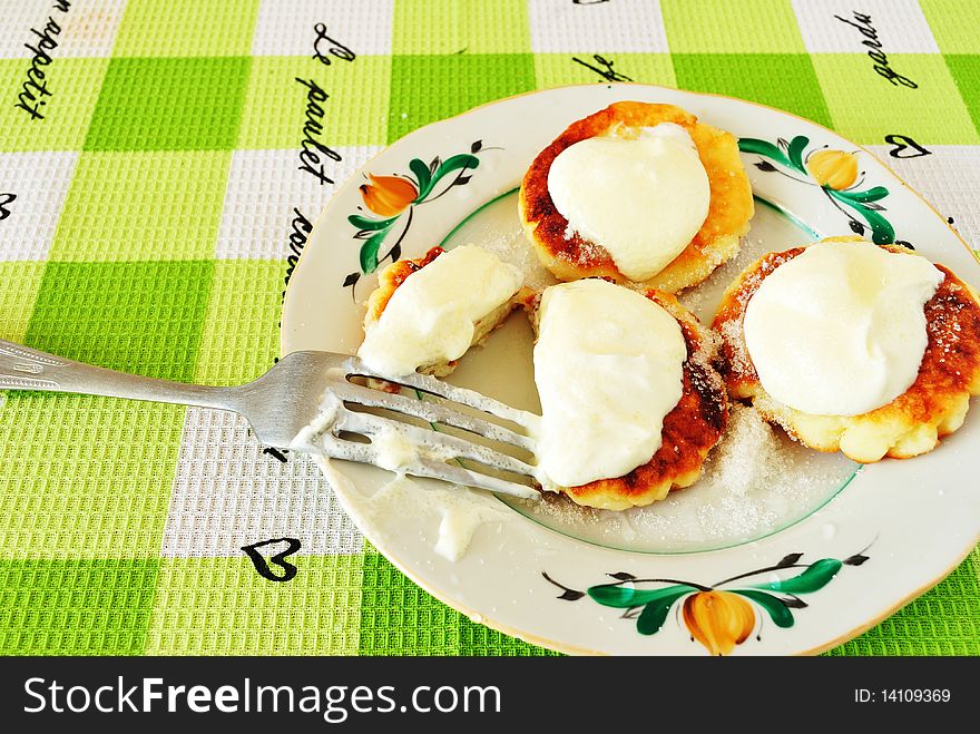 Image fried cheese fritters in a deep saucer with sour