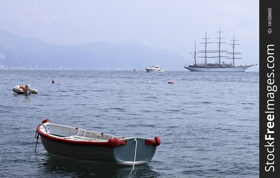 A particular detail of different boats with a tall ship on the foreground.