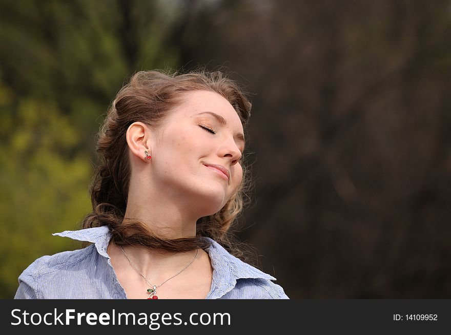 A young girl on a background of trees. A young girl on a background of trees