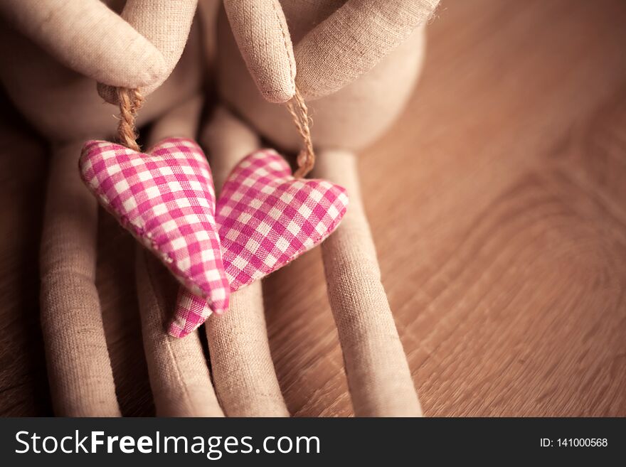 Couple handmade toys with pretty linen textile red hearts. Easter and Valentine Day holiday concept. Wedding theme. Couple handmade toys with pretty linen textile red hearts. Easter and Valentine Day holiday concept. Wedding theme.