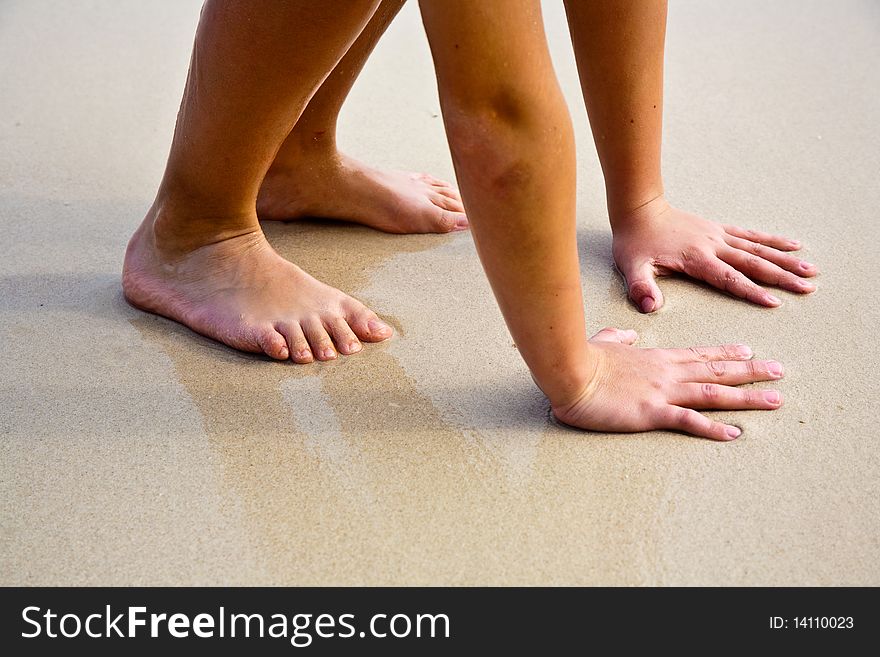 Feet on the beautiful sandy beach. Feet on the beautiful sandy beach