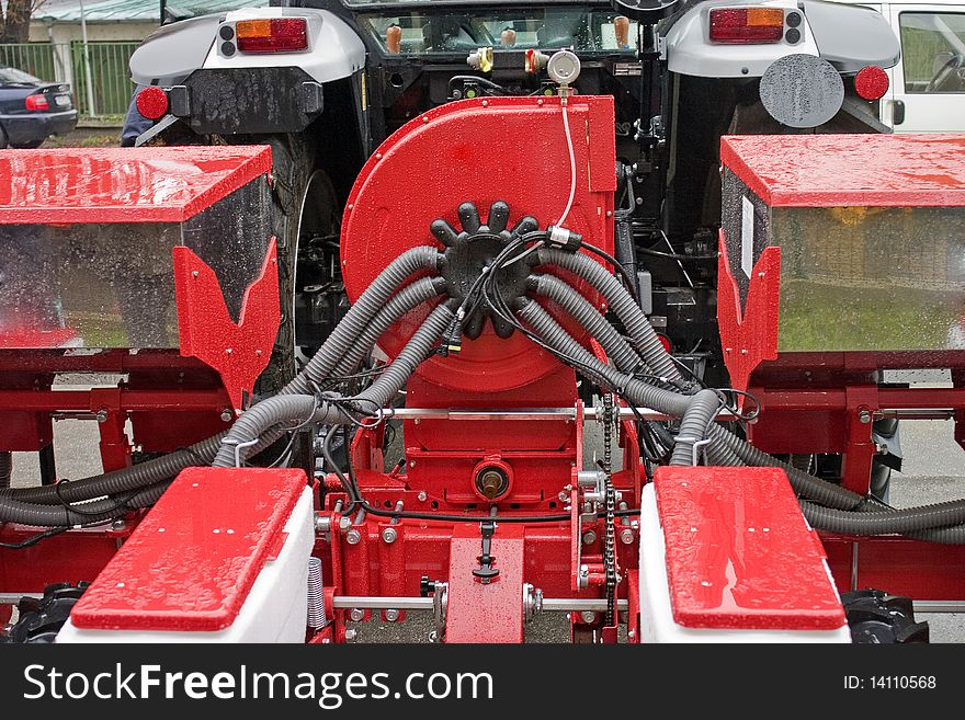 Close-up of farming tractor with equipment in red color. Close-up of farming tractor with equipment in red color.