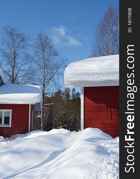 Red cottage houses on a bright winter day. Finland. Red cottage houses on a bright winter day. Finland.