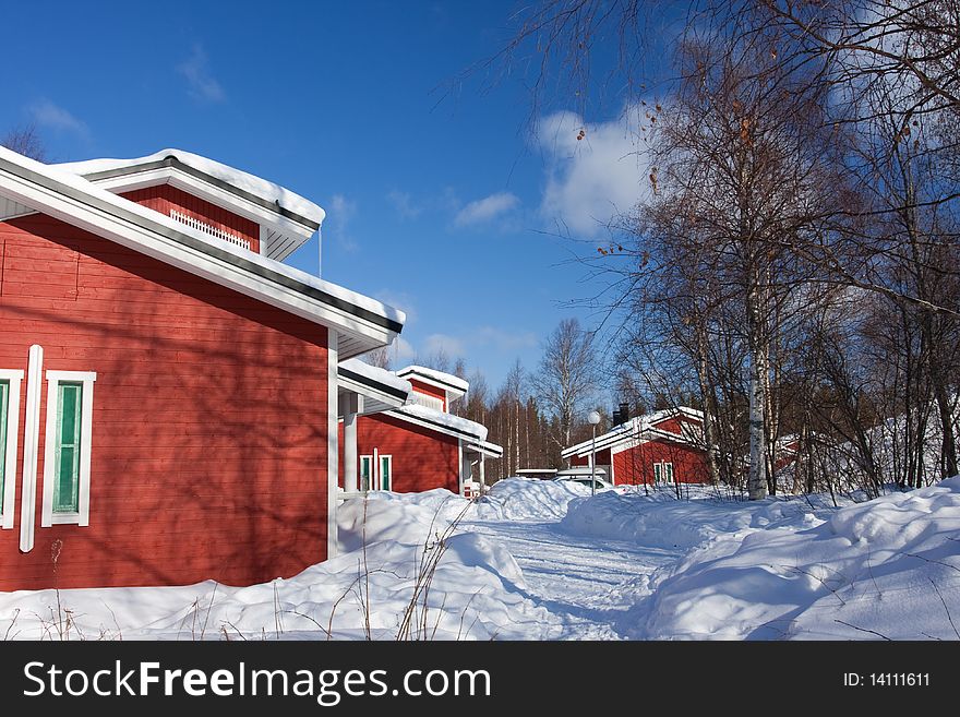 Red cottage houses on a bright winter day. Finland. Red cottage houses on a bright winter day. Finland.