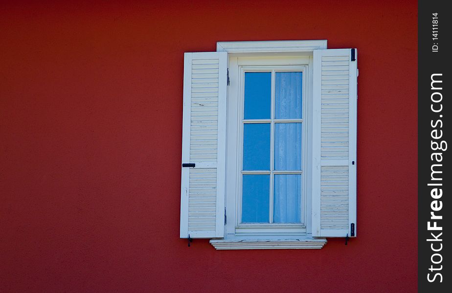 Small white framed window on country house