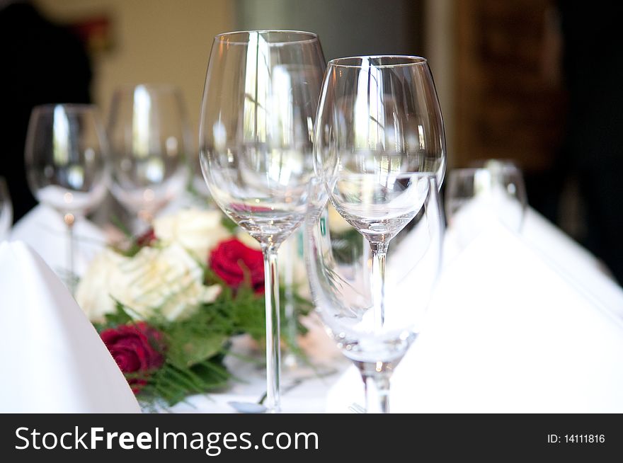 Table decoration with glasses and red roses