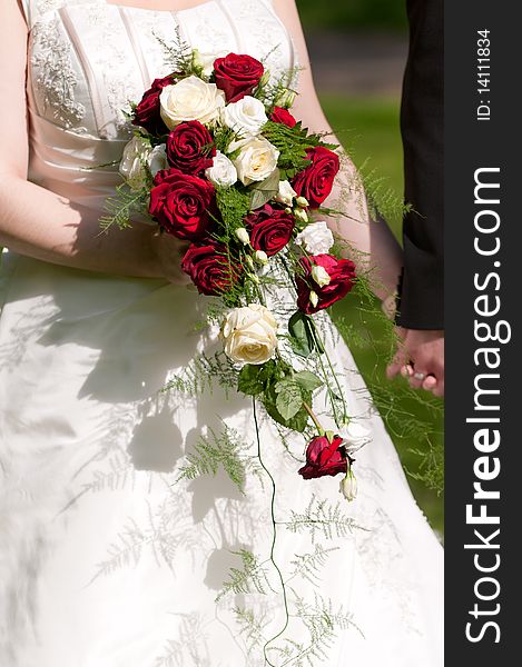 Bride holds Brautrauss with roses in hand. Bride holds Brautrauss with roses in hand