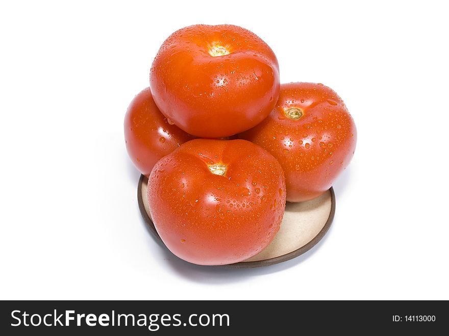 Four ripe, fresh tomatoes, coverd drops of water, on a plate on the white background. Four ripe, fresh tomatoes, coverd drops of water, on a plate on the white background