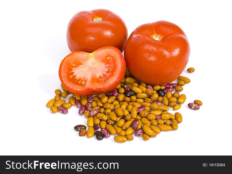 Ripe tomatoes, one of them are cut, and colorful beans isolated on the white background. Ripe tomatoes, one of them are cut, and colorful beans isolated on the white background