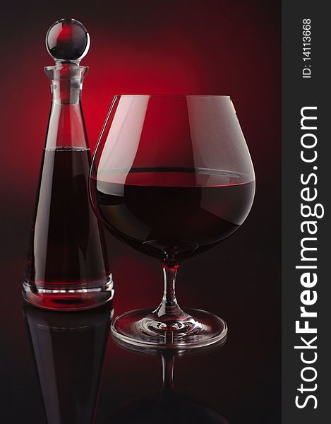 Red wine with carafe on red and black background