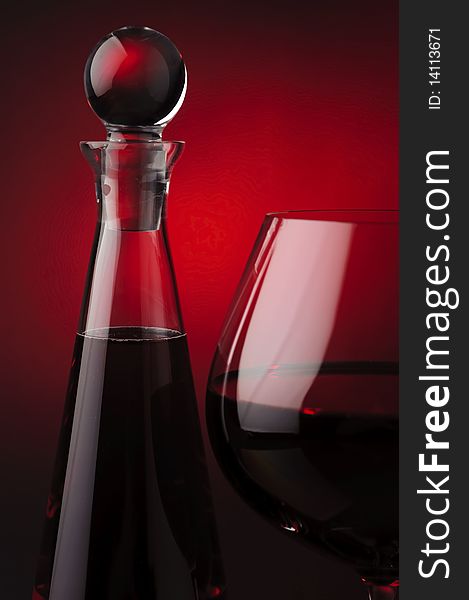 Red wine with carafe on red and black background