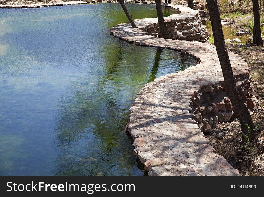 The curving edge of the water pool in spring daylight