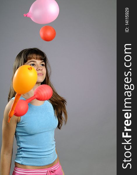 Beautiful child partying with colored objects in studio. Beautiful child partying with colored objects in studio