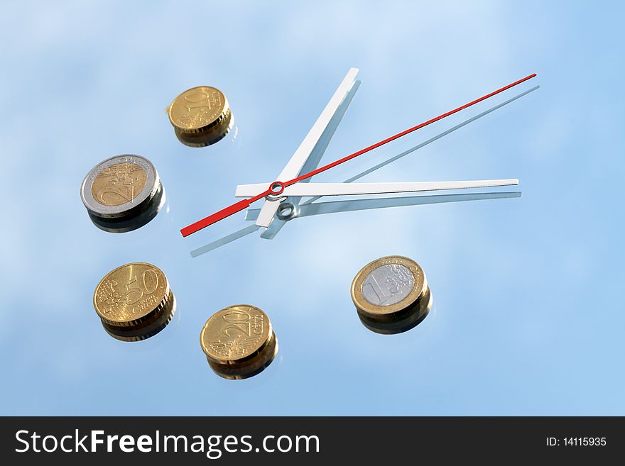Clock hands and few euro coins lying on mirror background with blue sky and clouds reverberation. Clock hands and few euro coins lying on mirror background with blue sky and clouds reverberation