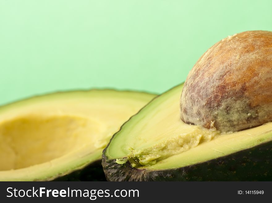 Close up of an avocado on a green background