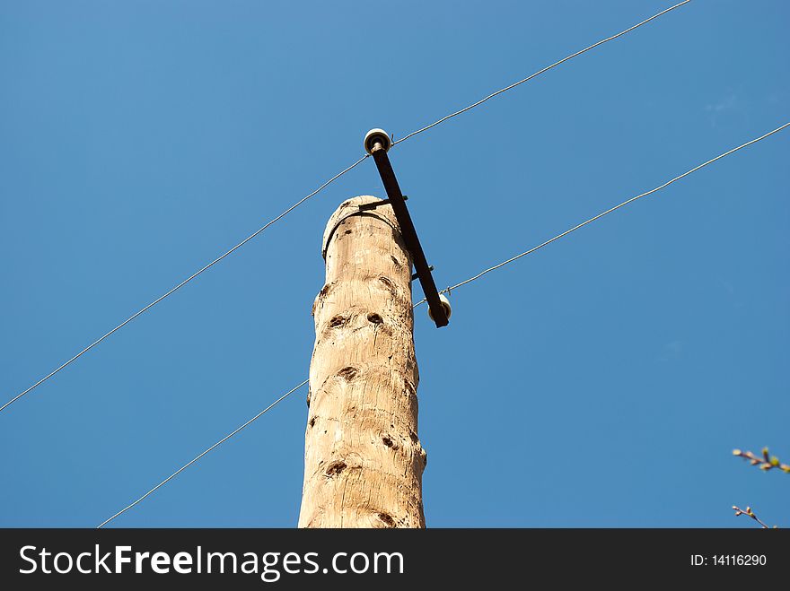 Old concrete column with wires on a background of the sky. Old concrete column with wires on a background of the sky