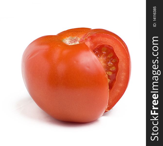 Isolated fresh tomato cut into pieces