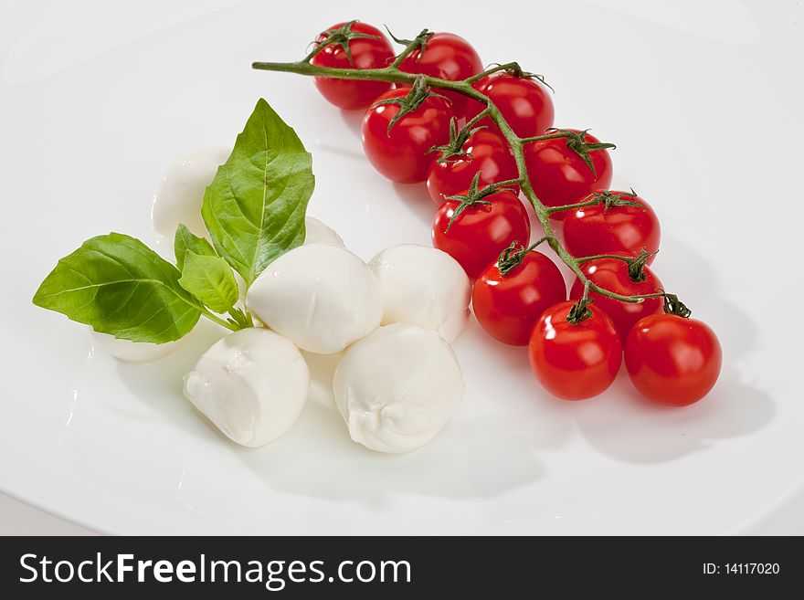 Food series: mozzarella, tomato and basil over white