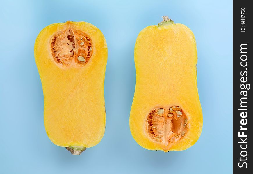 Butternut pumpkin isolated against a blue background