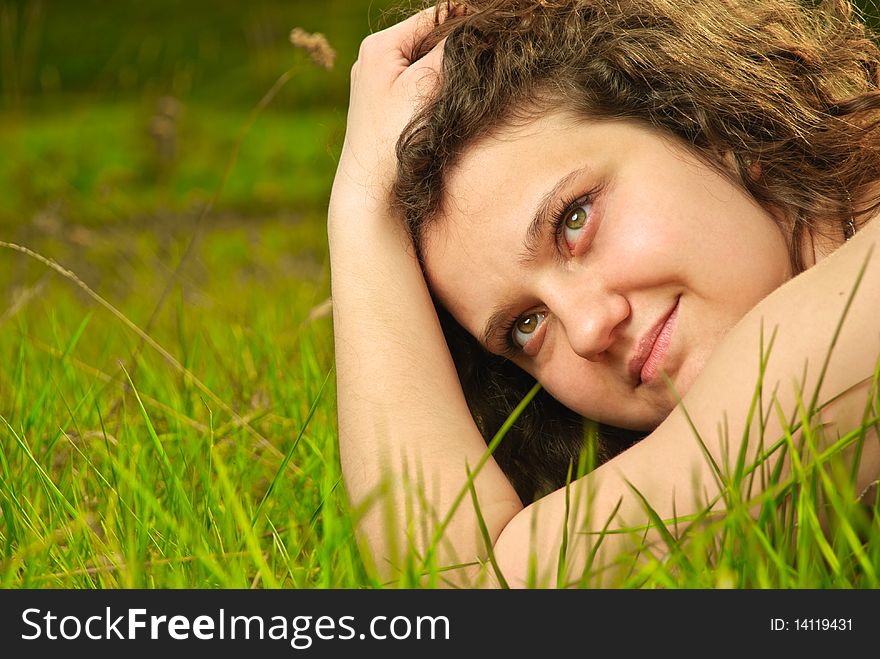 Beautiful young woman portrait at spring meadow grass. Beautiful young woman portrait at spring meadow grass