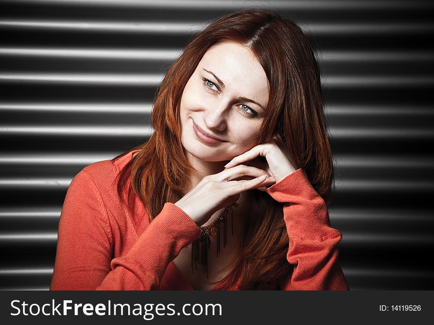 Young woman smiling at metallic background. Young woman smiling at metallic background