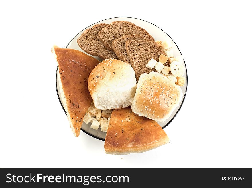 White bread,pita, crackers,rye bread in a plate on a white background. White bread,pita, crackers,rye bread in a plate on a white background