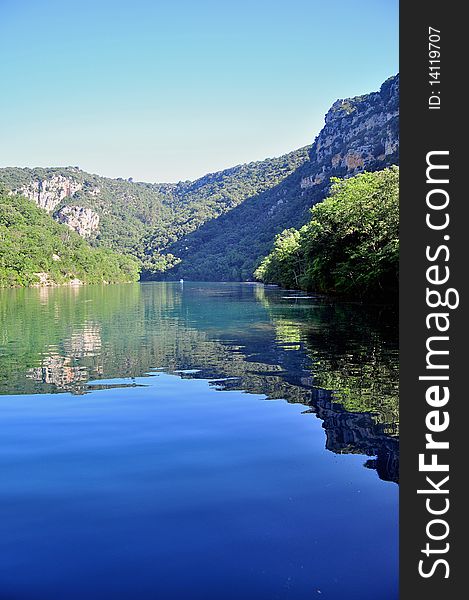 Photo taken on the Verdon River with reflections of the Hill in the water