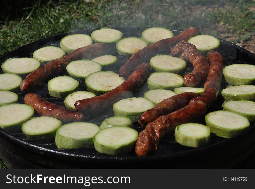 Sausages with grilled zucchini on sunny day. Sausages with grilled zucchini on sunny day