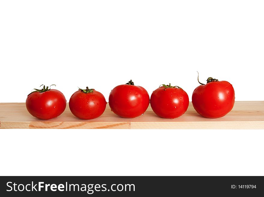 A five tomatos on desk isolated on white