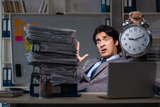 The Young Male Employee Working Late At Office Royalty Free Stock Photos