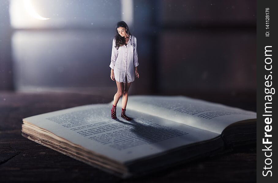 Good night concept with shrinked young woman reading book. Miniature unreal dreamy scene with moonlight