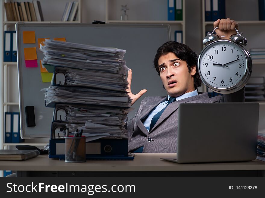 The Young Male Employee Working Late At Office