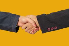 Close Up Of Business Handshake Isolate On Yellow Blackground Stock Photos
