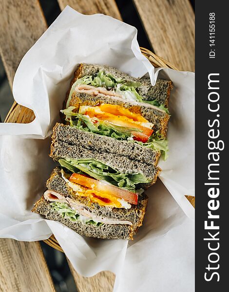 Black Sesame Toast Sandwich. Bread with chicken, egg and vegetables, a healthy style breakfast