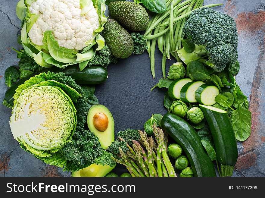 Assortment of healthy organic green vegetables for balanced eating. Vegan, vegetarian, whole food, plant based, clean eating concept. Top view flat lay copy space background. Assortment of healthy organic green vegetables for balanced eating. Vegan, vegetarian, whole food, plant based, clean eating concept. Top view flat lay copy space background