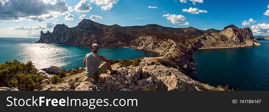 Hiker on beauty landscape Crimea  New World, Novy Svet background, travel and vacation concept, panoramic view. Hiker on beauty landscape Crimea  New World, Novy Svet background, travel and vacation concept, panoramic view