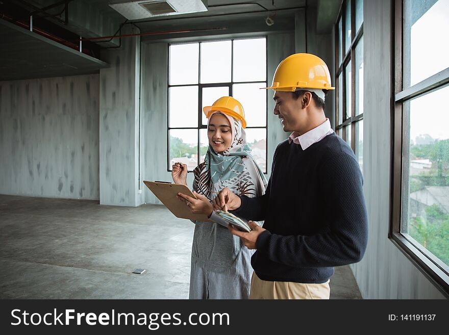 Businessman with protective hardhats working together