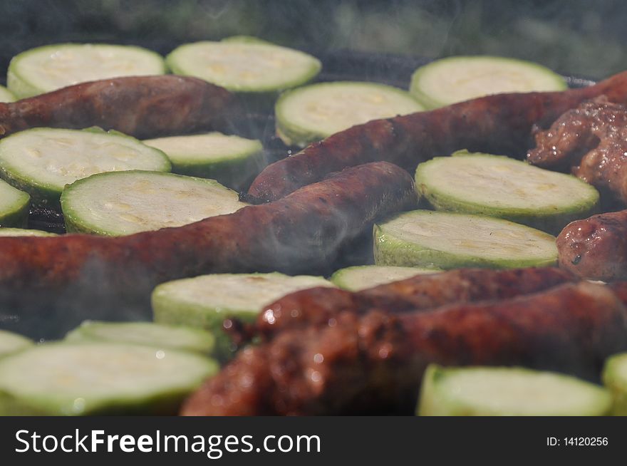 Sausages with grilled zucchini on sunny day. Sausages with grilled zucchini on sunny day