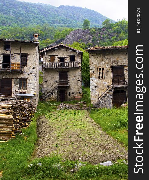 Old and dilapidated stone houses with garden